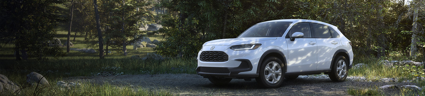 2025 Honda HR-V parked in a lush forest.